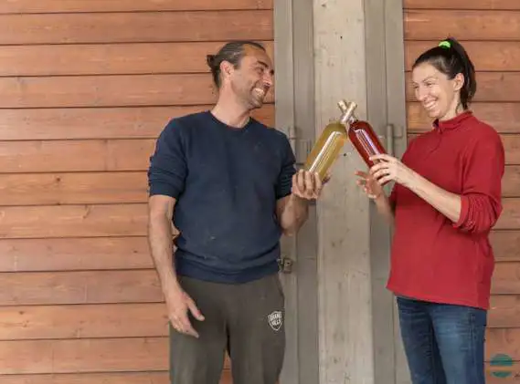 Foto dei due fratelli produttori di vino in cantina durante operazioni di imbottigliamento